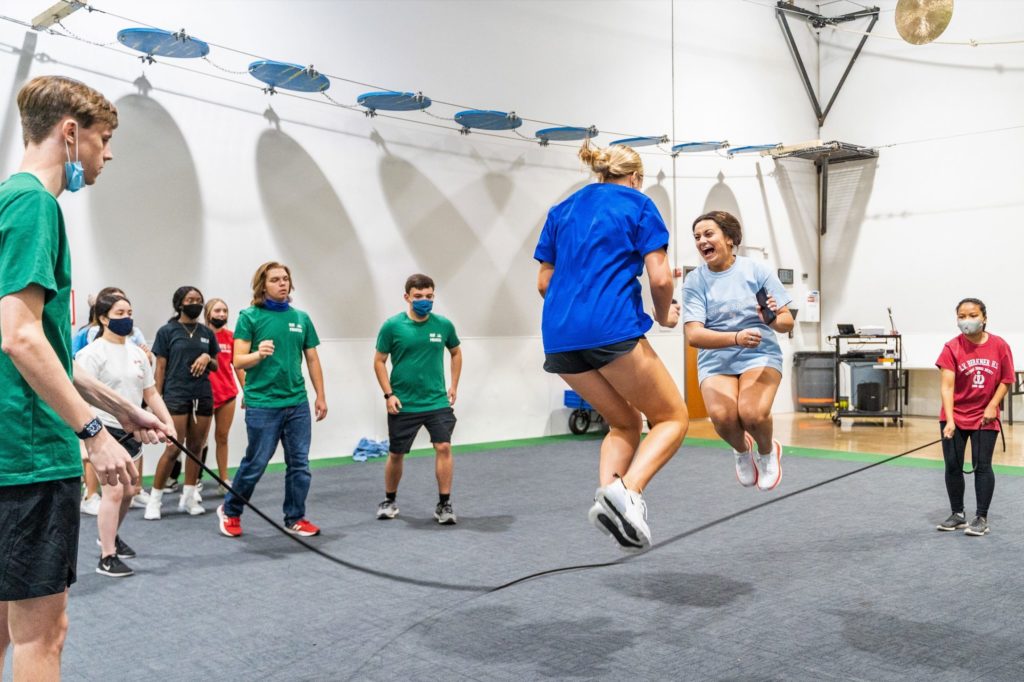 Group of high school students jumping rope during a team building event