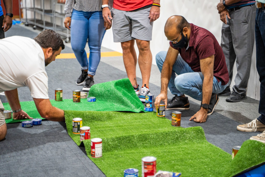 Corporate group building a mini golf course during a charity event