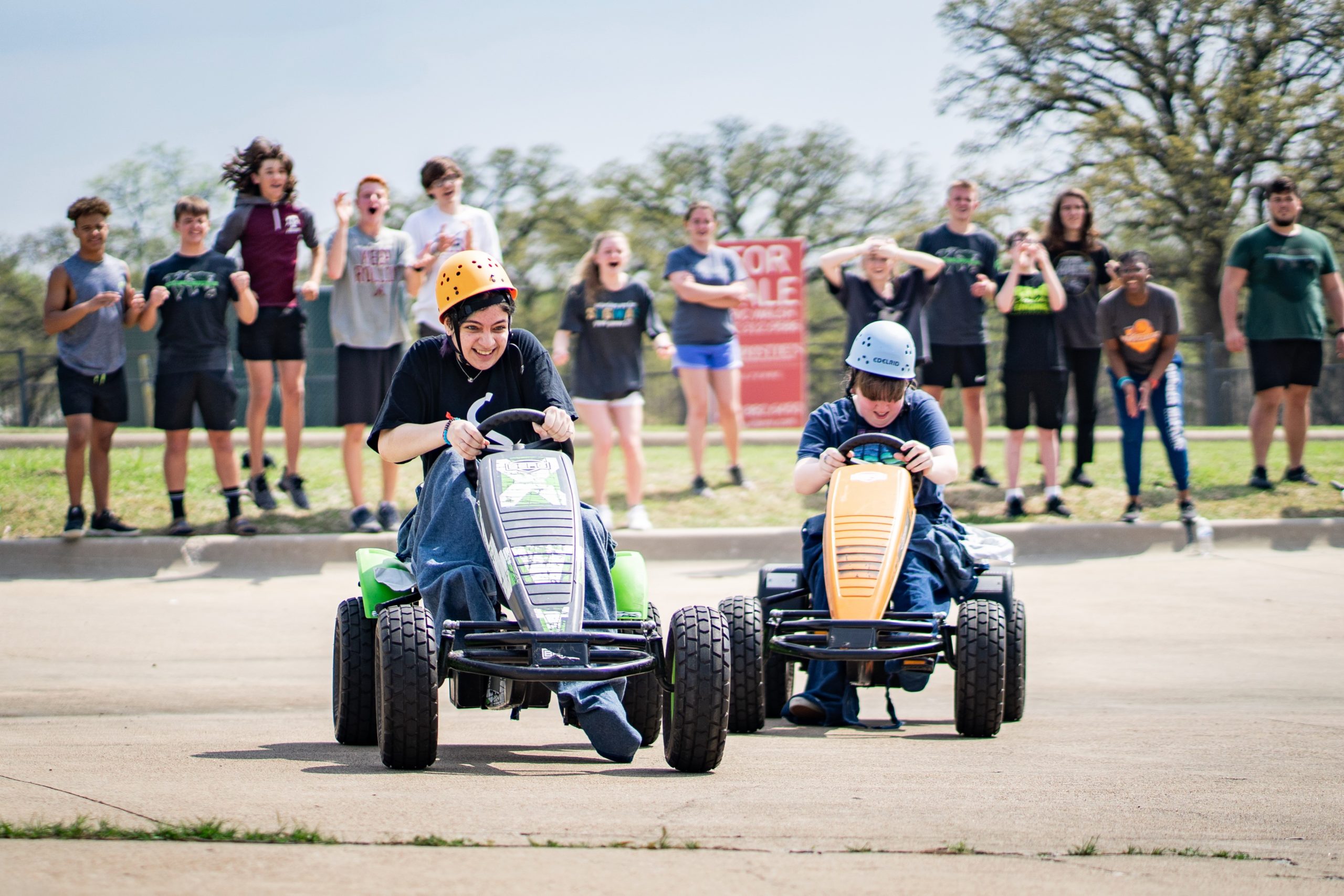 Two students racing on go-carts during a church youth portable event led by Group Dynamix