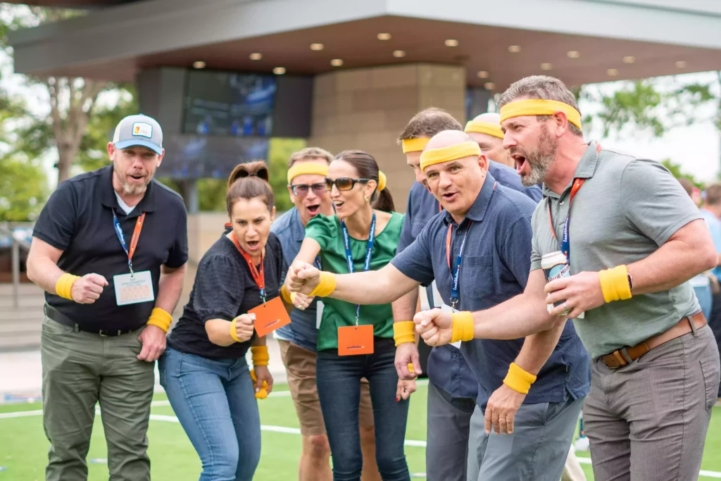 A corporate team chant and cheer during a team building event at AT&T Stadium 