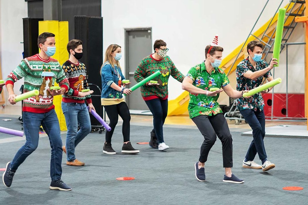 Group of teenagers in a huddle during a team building activity at Group Dynamix