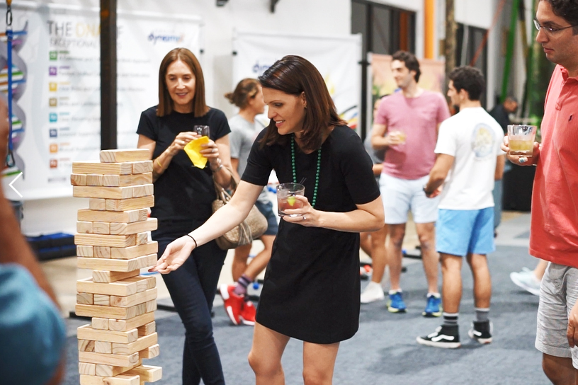 Group of adults playing giant jenga during an social event