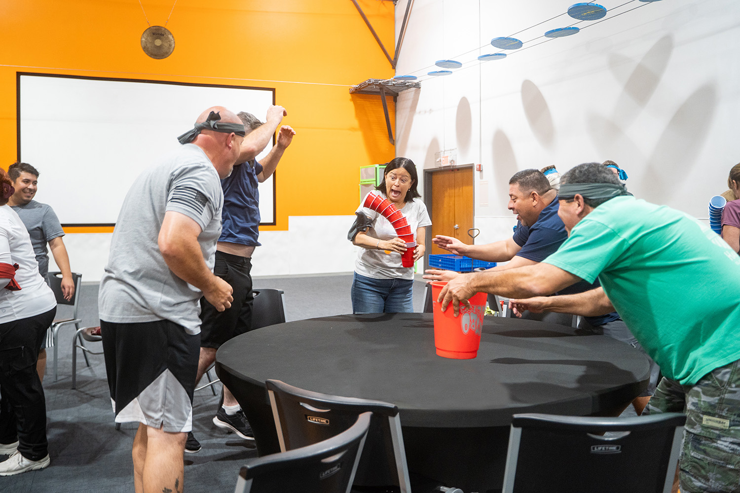 Group of teenagers in a huddle during a team building activity at Group Dynamix