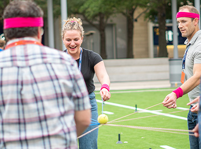 Group of colleagues playing a game during a portable team building event 