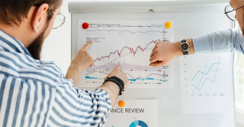 Two coworkers analyzing charts and performance data to evaluate results from fun staff training ideas and engagement strategies.