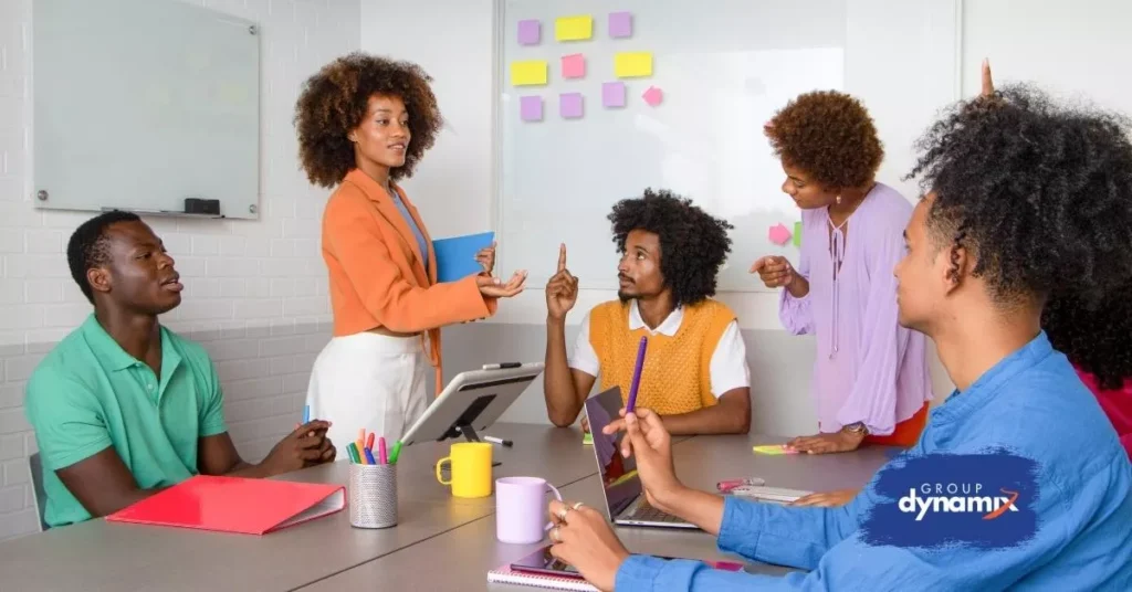 Team brainstorming together in a colorful office discussing creative and fun staff training ideas to improve collaboration and motivation.
