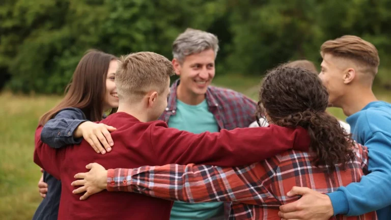 Team gathered in an outdoor huddle participating in quick team building exercises.