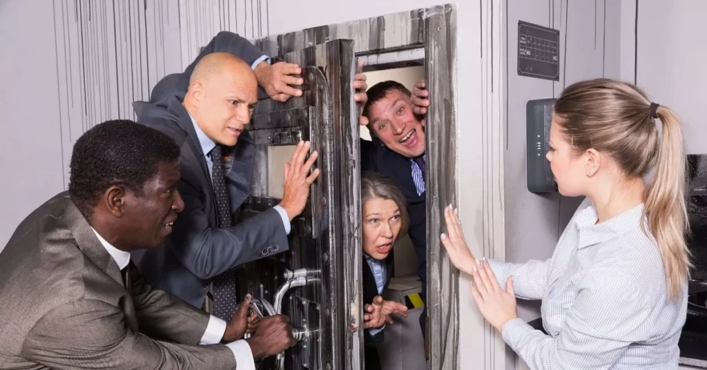 Coworkers participating in an escape room as one of many end of year celebration ideas.
