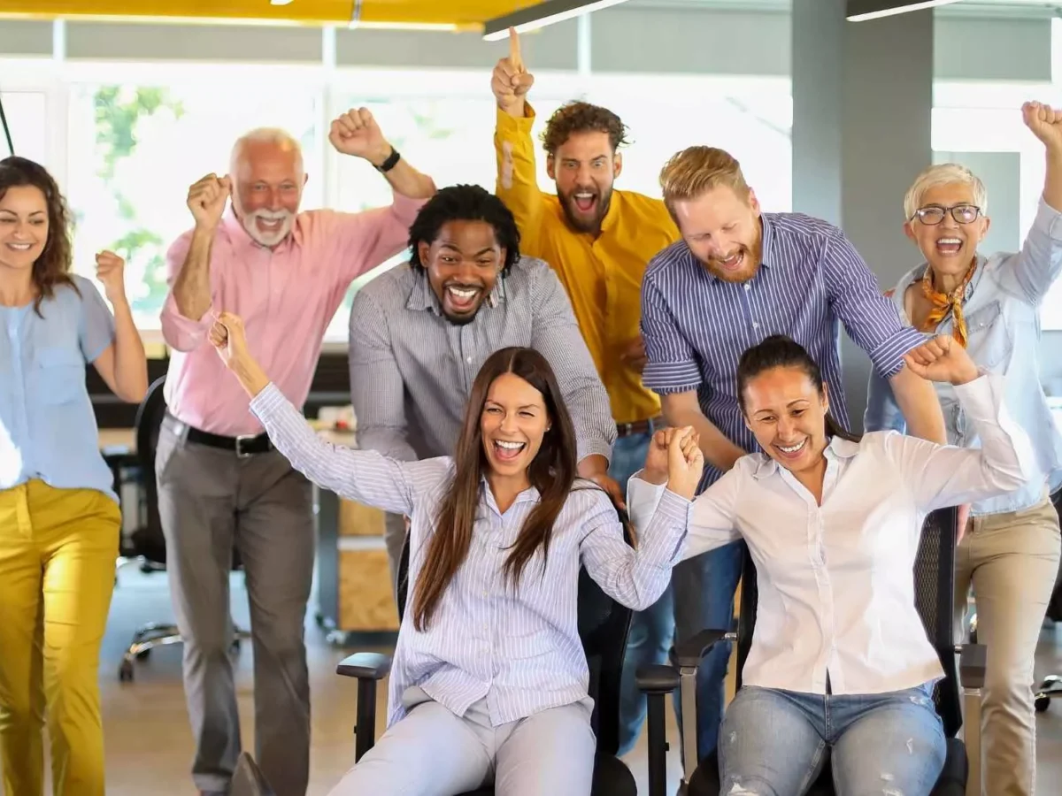 Fun team building activity with happy colleagues collaborating together